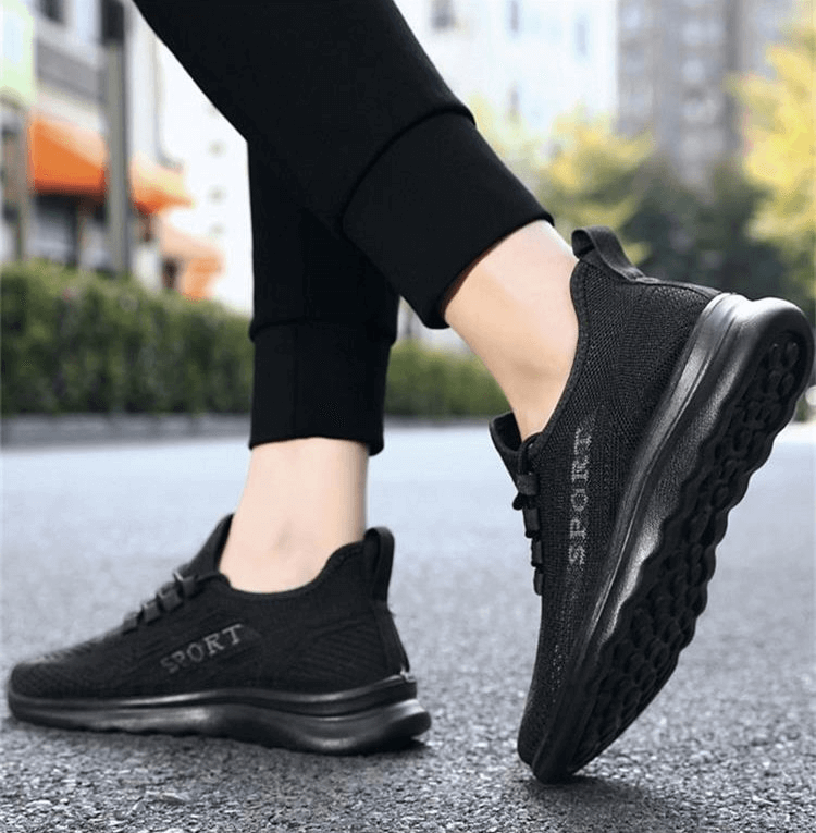 Stylish breathable black lace up sneakers for men shown outdoors, perfect for comfort and flexibility, model SF0980.